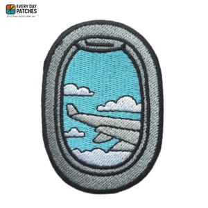 May include: Embroidered patch showing an airplane wing viewed through a plane window. The window frame is grey, with a blue sky and white clouds. The patch includes the text "EVERY DAY PATCHES" at the top.