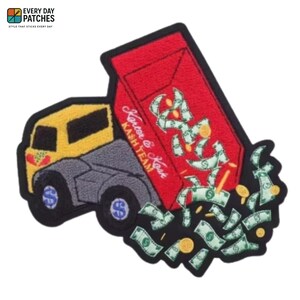 May include: Embroidered patch featuring a yellow and gray dump truck with a red bed overflowing with money. The patch has the text "Karter & Kase KASH TEAM" in white script. Green dollar bills and gold coins are falling from the truck.