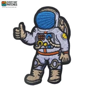 May include: Embroidered patch featuring a cartoon astronaut in a white spacesuit with blue helmet and orange accents. The astronaut is giving a thumbs-up gesture. The patch has the text "EVERY DAY PATCHES" at the top.