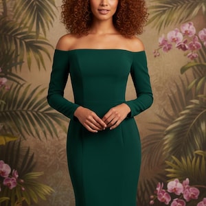 May include: A long-sleeved, off-the-shoulder emerald green dress. The dress has a fitted bodice and a floor-length skirt. The model is standing in front of a tropical floral background. The dress is a solid color and appears to be made of a smooth fabric.