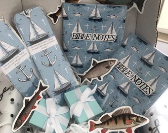 May include: A gift box containing two light blue notebooks labeled BIBLE NOTES, two matching bookmarks with sailboat and anchor illustrations, two small light blue gift boxes with white ribbons, and four assorted fish-shaped stickers.