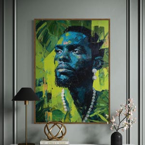 May include: A framed portrait of a person with blue skin and a black beard, wearing a pearl necklace and earrings. The background is a vibrant mix of green and yellow, with leafy patterns. The artwork is displayed above a marble-topped table with a black lamp and decorative items.