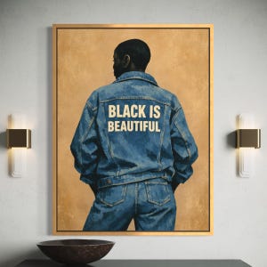 May include: A framed art print featuring a person wearing a denim jacket and jeans, viewed from the back. The jacket has the text "BLACK IS BEAUTIFUL" in white. The background is a warm, neutral tone.