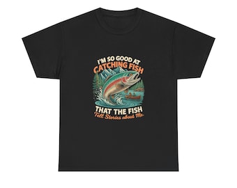 May include: Black t-shirt with a colorful graphic of a fish jumping out of water, mountains, and a boat. Text reads "I'm so good at catching fish that the fish tell stories about me."