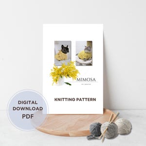 May include: A digital download PDF knitting pattern titled MIMOSA PET SWEATER. The document features photos of a French Bulldog and a cat wearing yellow sweaters, a bouquet of yellow mimosa flowers, and three balls of yarn with knitting needles.