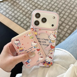 May include: A pink phone case and card holder featuring Hello Kitty designs. The phone case has a clear back with a pink border and a glittery star shape. The card holder and case are decorated with Hello Kitty, cupcakes, and strawberries.