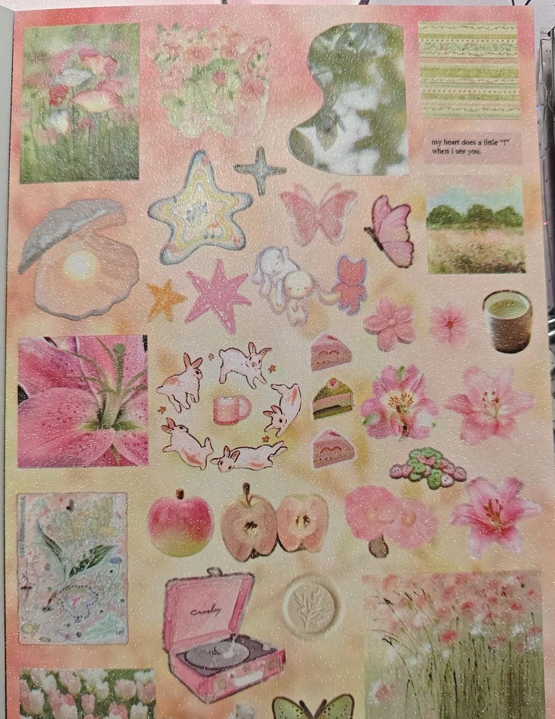 May include: A sticker sheet featuring a variety of illustrations including pink lilies, rabbits, a pink record player, apples, butterflies, a pearl in a shell, and a cup of tea. The sheet includes the text, my heart does a little "t" when i see you.