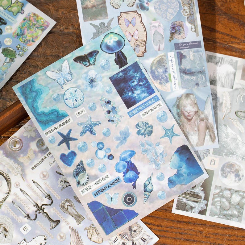 Blue-toned collage sticker sheet with ocean-inspired elements, stars, butterflies, and abstract shapes for journaling decoration.