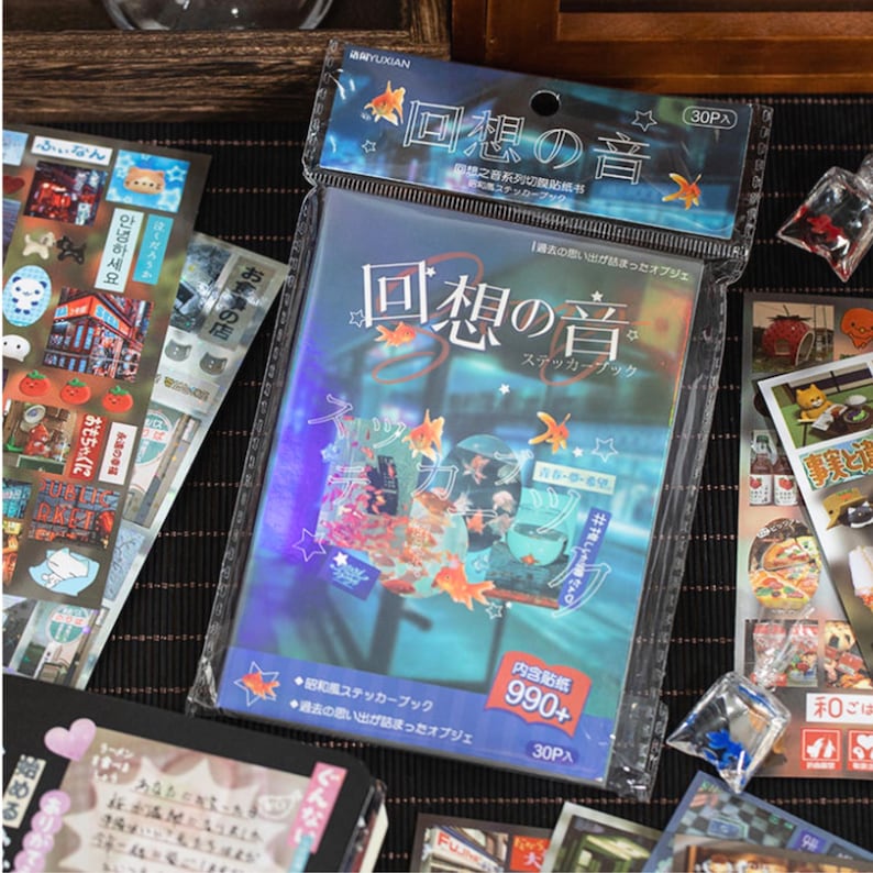 Japanese retro aesthetic sticker book with 900 mixed stickers, hand-held cover display for journaling and scrapbooking.