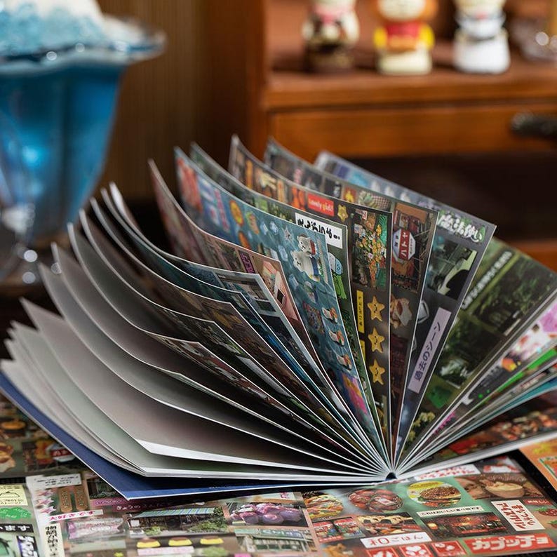 Flip-through view of the 900-piece Japanese retro sticker book with assorted aesthetic stickers for scrapbooking and crafting.