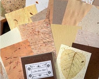 May include: A collection of various textured papers in shades of brown, beige, and cream. Some papers have embedded leaves and floral elements. A brown notebook with a floral label is visible. The text "RETRO MATERIAL PAPER" is at the top.