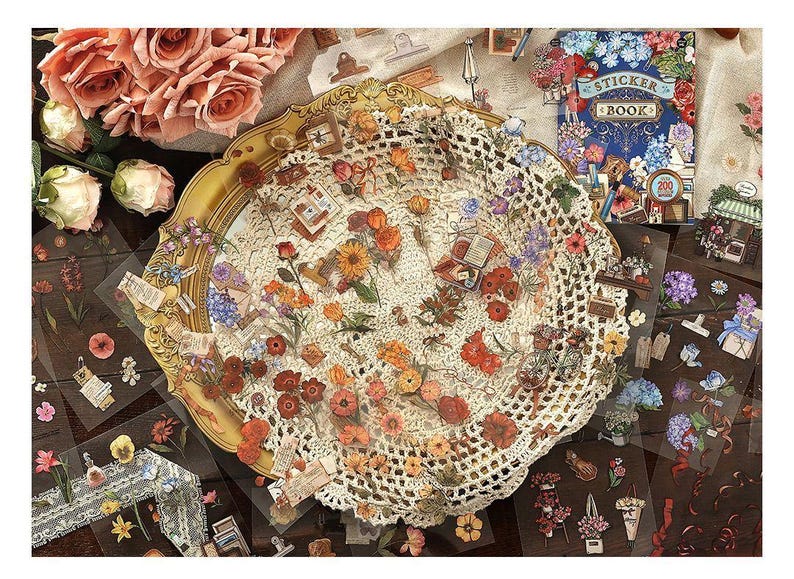 May include: A collection of floral stickers and a sticker book are arranged on a table. The stickers feature various flowers, books, and other decorative elements. A gold-rimmed tray with a doily and roses are also present.