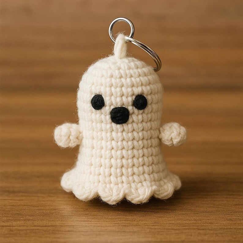 Puede incluir: Un llavero de fantasma de ganchillo hecho a mano, de color crema, con ojos y boca negros. El fantasma tiene brazos peque&ntilde;os y un borde inferior festoneado. Un llavero plateado est&aacute; unido a la parte superior. Un accesorio encantador y caprichoso.