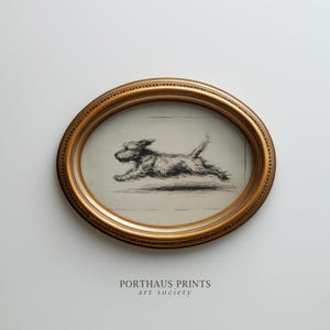 May include: An oval framed print featuring a running dog illustration in black and white. The frame is gold-colored with a detailed edge. The print is from Porthaus Prints, art society.