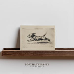 May include: A black and white print of a dog in mid-run. The dog is a terrier breed, with a fluffy coat and a raised tail. The print is on a beige background, with the text "PORTHAUS PRINTS art society" at the bottom.