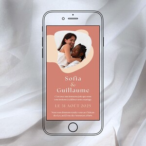以下が含まれることがあります： スマートフォンに表示された結婚式の招待状。2人が抱き合っている写真が、桃色の背景に配置され、「Sofia & Guillaume」の名前と「LE 31 AOÛT 2025」の日付が記載されています。