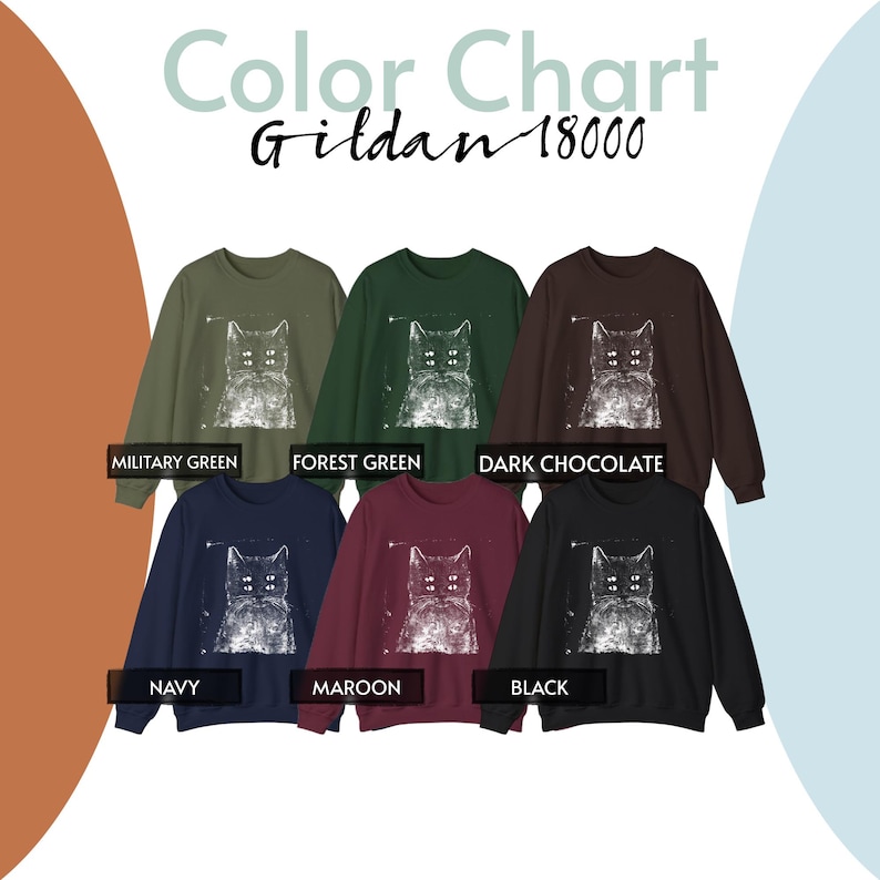 May include: A Gildan 18000 colour chart featuring six crewneck sweatshirts in military green, forest green, dark chocolate, navy, maroon, and black. Each sweatshirt displays a white graphic print of a cat with four eyes. Text labels identify each colour.