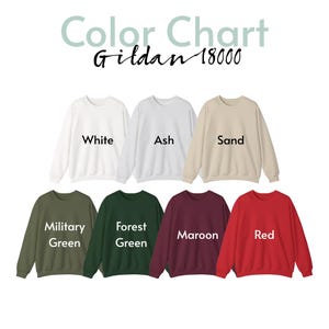 May include: Color chart of Gildan 18000 sweatshirts in various colors, including white, ash, sand, military green, forest green, maroon, and red. The text "Color Chart" and "Gildan 18000" are displayed at the top.