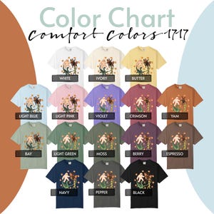 May include: A Comfort Colors 1717 color chart displaying fifteen t-shirts in various shades including white, ivory, butter, light blue, light pink, violet, crimson, yam, bay, light green, moss, berry, espresso, navy, pepper, and black with a graphic.