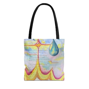 May include: Tote bag with a colorful watercolor design. The bag features a black handle and a print with a poem and a large blue teardrop shape. The background has yellow, pink, and blue hues.