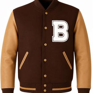 May include: Brown varsity jacket with tan leather sleeves. The jacket features a large white "B" patch on the chest, gold snap closures, and tan and brown striped ribbed cuffs and hem. A classic style.
