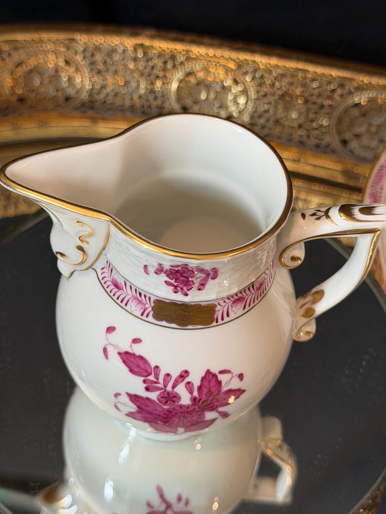 May include: A set of three ceramic mugs with a speckled, matte finish. The mugs are in shades of cream, light gray, and dark gray. Each mug has a simple, minimalist design, perfect for coffee or tea.