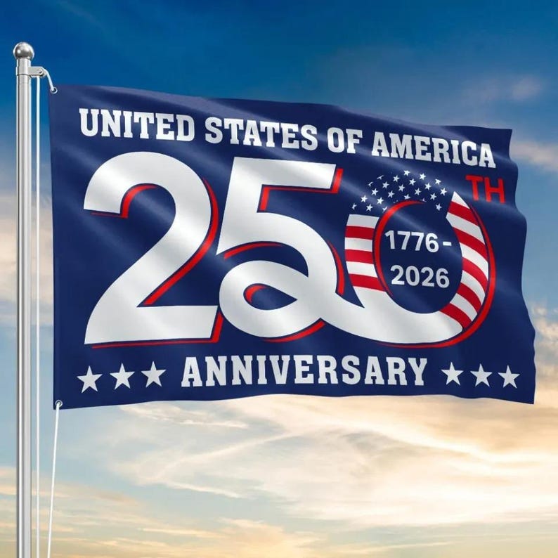 May include: A blue flag with white text that reads "UNITED STATES OF AMERICA" and "250TH ANNIVERSARY". The number "250" is in white with a red outline, and the flag features the American flag design.