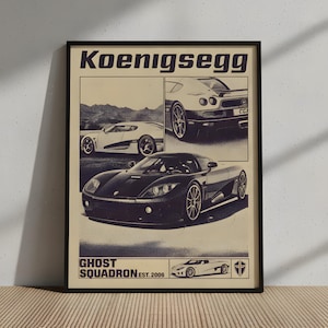 May include: A framed poster with a retro design, displaying the word "Koenigsegg" at the top. The poster features images of Koenigsegg cars, with the text "Ghost Squadron Est. 2006" at the bottom. The colour scheme is mainly black and beige.