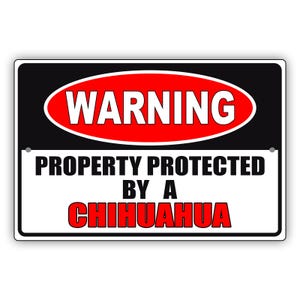 May include: A rectangular sign with a black border and a white background. The top section has a red oval with the word "WARNING" in white. The bottom section reads "PROPERTY PROTECTED BY A CHIHUAHUA" in bold black and red text.