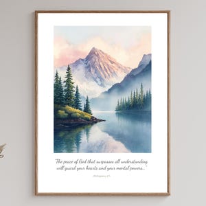 May include: A framed watercolor print of a mountain landscape with a lake and evergreen trees. The artwork features a mountain range with a pink and blue sky. Text at the bottom reads: "The peace of God that surpasses all understanding will guard your hearts and your mental powers..."