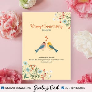 May include: A greeting card with the words "Happy Anniversary" and "Lovebirds" in a decorative font. The card features two illustrated birds and the quote "Two are better than one." Card size is 5x7 inches.