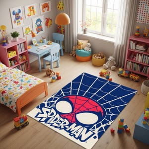 May include: A blue and white Spider-Man area rug with a red and white Spider-Man face design. The rug is rectangular and features the words "Spider-Man" in white. The rug is in a child's bedroom with toys and furniture.