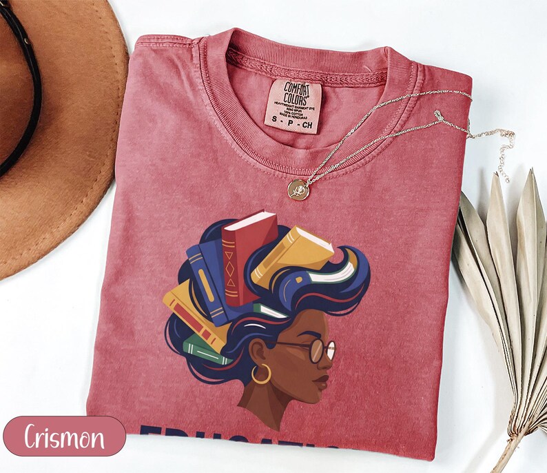 Crimson t-shirt with woman's profile and books in her hair, "Crismon" watermark.