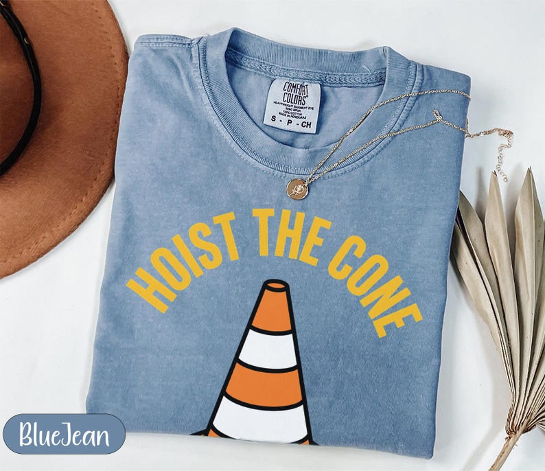 Blue t-shirt with "HOIST THE CONE" text and traffic cone graphic.