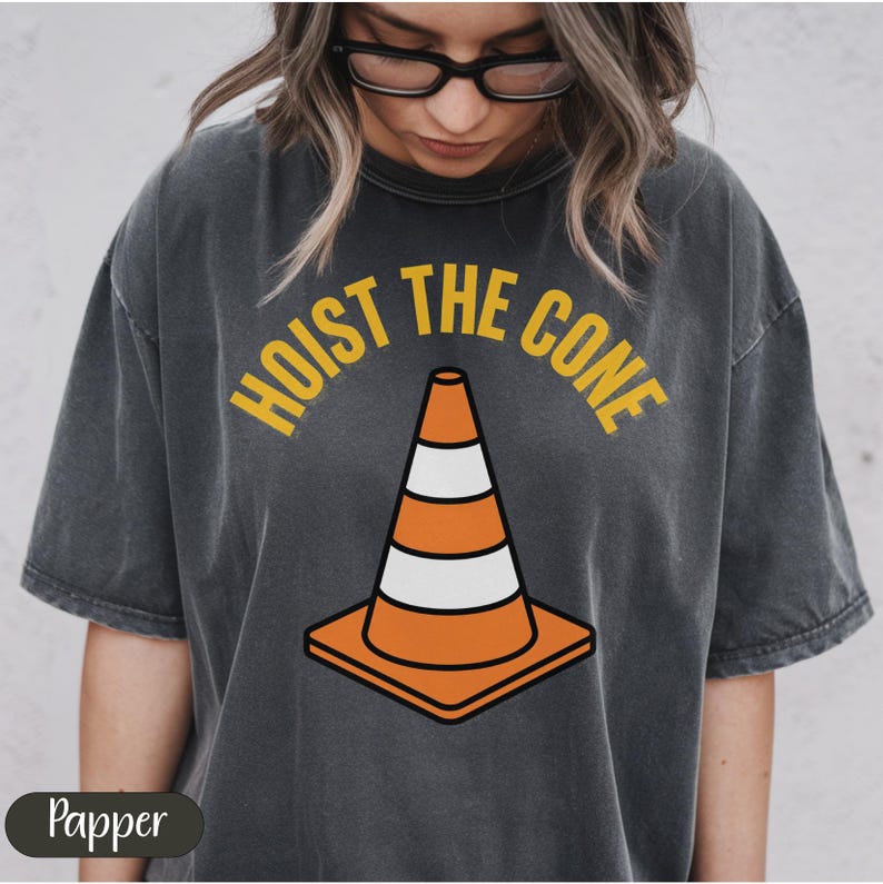 Black t-shirt with "Hoist the cone" text and traffic cone graphic.