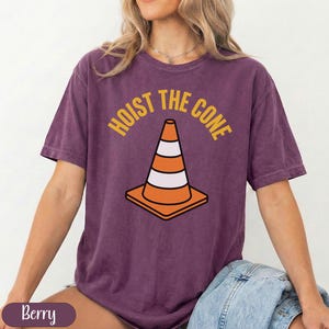 T-shirt with "Hoist the Cone" text and orange traffic cone graphic.