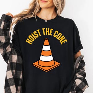 T-shirt with orange and white traffic cone graphic and "Hoist the Cone" text.