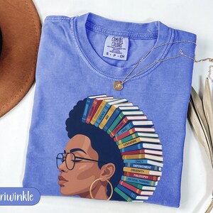 T-shirt with a woman's profile and books for hair, with words like "History" and "Philosophy."