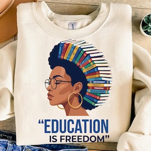 Woman with books in her hair, wearing glasses, text "EDUCATION IS FREEDOM".