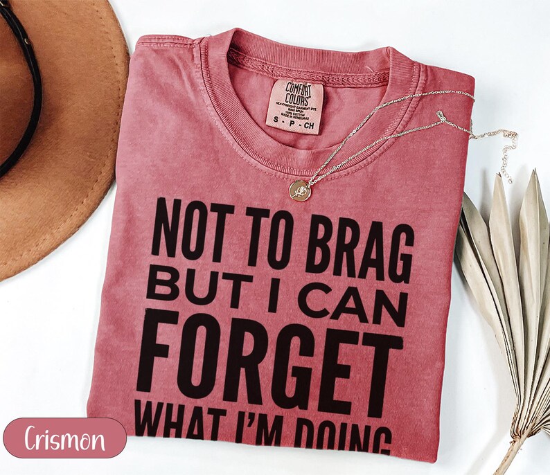 Crimson t-shirt with "Not to brag but I can forget what I'm doing" text.