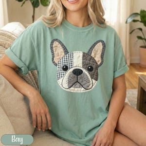 Green t-shirt with a patch of a French bulldog's face.