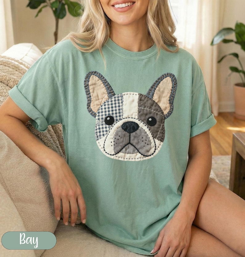 Green t-shirt with a patch of a French bulldog's face.