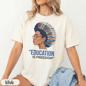 Woman with books in her hair and "Education is Freedom" text.