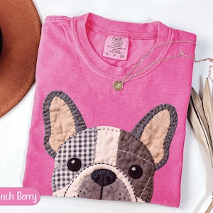 Pink t-shirt with French bulldog patch, "Crunch Berry" label.