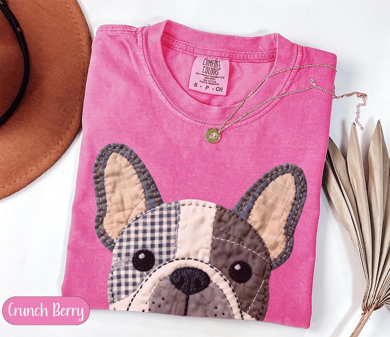 Pink t-shirt with French bulldog patch, "Crunch Berry" label.