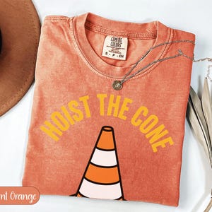 Orange t-shirt with "HOIST THE CONE" graphic and traffic cone.