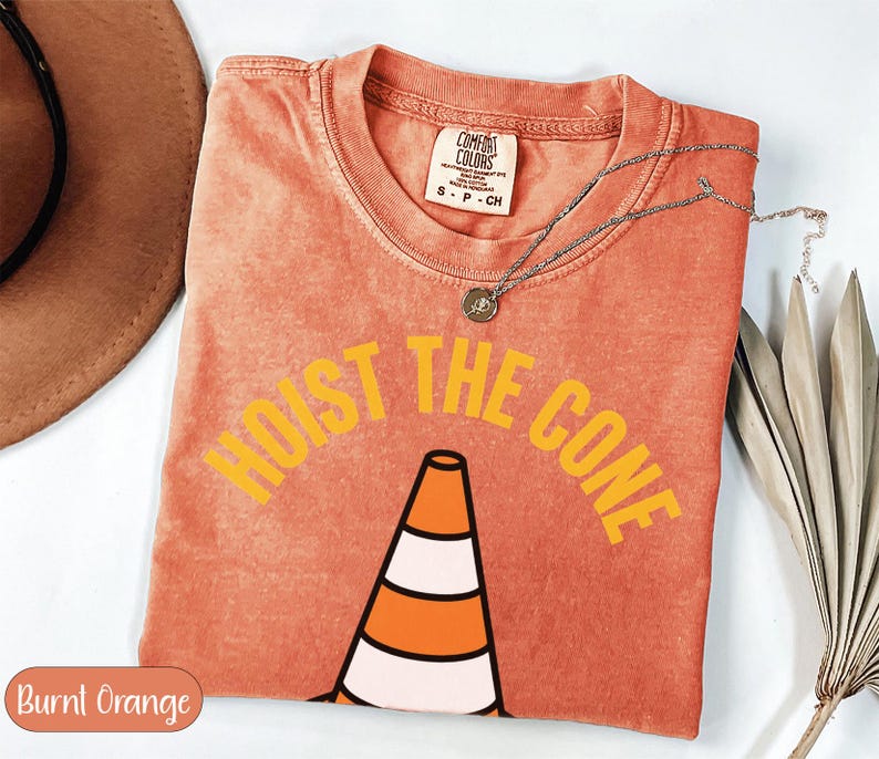 Orange t-shirt with "HOIST THE CONE" graphic and traffic cone.