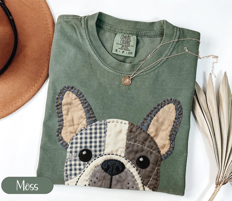 Green t-shirt with a patchwork French bulldog graphic, "Moss" text.