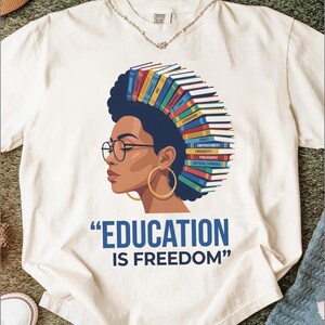 Woman with books forming her hair, quotes "EDUCATION IS FREEDOM".