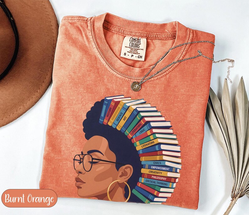 T-shirt with woman's profile and books forming her hair, "Burnt Orange" text.